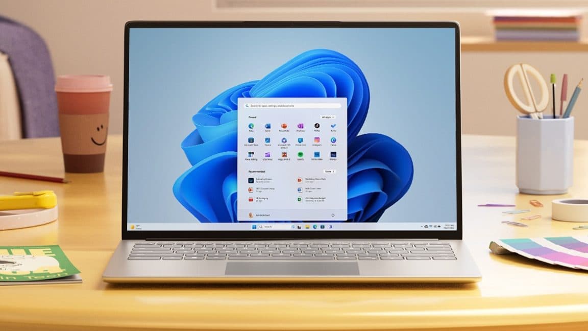 Microsoft logo with Windows 11 interface in the background